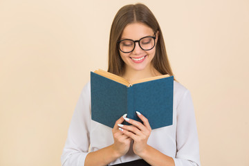 beautiful young woman in glasses with a book in her hands