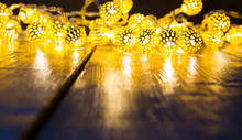 Yellow Christmas Lights Background With Wooden Floor