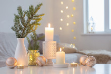 Christmas Decorations With Burning Candles In White Interior
