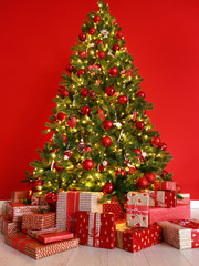 Wall Mural - christmas tree on the background of red empty wall.