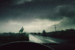 © Cosma Andrei/Stocksy - Dashboard rain on car windshield during storm