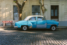 Blue Vintage Car Parked On The Street.