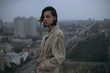 © Dmytro Bilous/Stocksy - Thoughtful young woman in coat standing in city