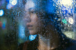© Dmytro Bilous/Stocksy - Portrait of young woman looking through wet glass