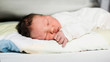© Ira Efremova Photography/Stocksy - Newborn baby laying on a bed