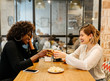 © Marco Govel/Stocksy - Two girlfriends in a restaurant