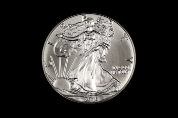 Wall Mural - An American one ounce silver Eagle coin, shot close up in macro on a solid black background