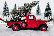 Red Pickup Truck In Snow With Christmas Tree
