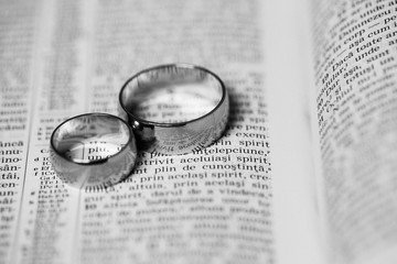 The wedding and love conceptual. Wedding rings. Two wedding rings on a bible. Wedding rings on the page of the book