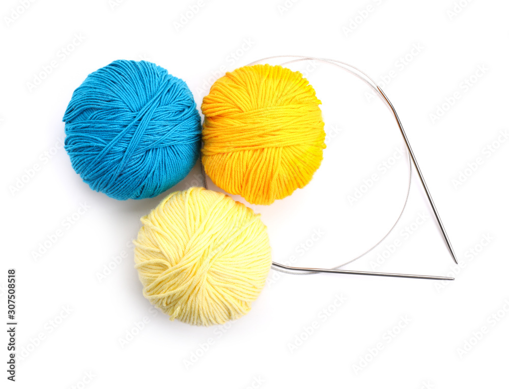 Knitting yarns and needles on white background