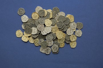 Sticker - Overhead shot of vintage coins on a dark blue surface