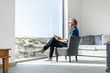 © Westend61 - Casual businessman sitting in modern home using tablet