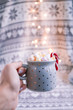 Cup full of marshmallows keeped in hand. Lifestyle, christmas photo with bokeh