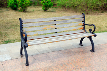 Wall Mural - Wooden chairs in parks and distant buildings