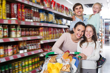 Wall Mural - Positive family with two daughters shopping