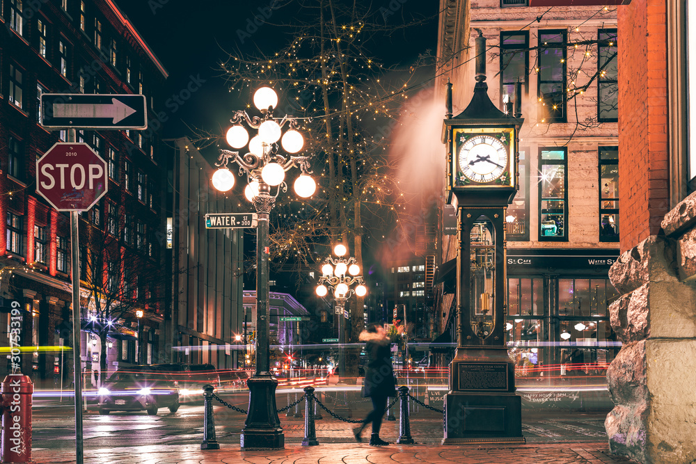 The famous Steam Clock in Gastown in Vancouver city with cars light trails at night - obrazy, fototapety, plakaty 