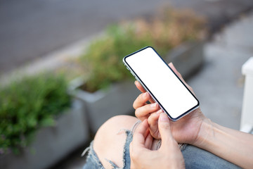 Mockup image blank white screen cell phone.men hand holding texting using mobile on desk at home office. background empty space for advertise text.people contact marketing business and technology 