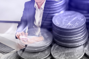 Rows of coins for finance background and banking concept, business woman use smart phone