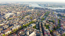 Amsterdam, Netherlands. Flying Over The City Rooftops Towards Amsterdam Central Station ( Amsterdam Centraal ), Aerial View