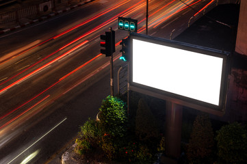 Large billboards on the street at night, with beautiful street lights.