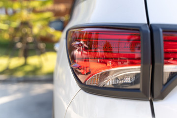 Wall Mural - Back view of new white car. white premium city crossover, rear light closeup. Car lamp close-up.