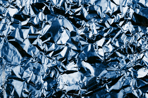Texture of crumpled foil. Trendy blue background.