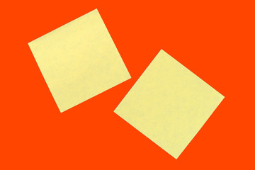 Wall Mural - Yellow sticker notes on a bright orange red. Business background, copy space