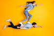 © deagreez - Top view above high angle flat lay flatlay lie full length body size view concept of his he her she beautiful handsome spouse flying isolated on bright vivid shine vibrant yellow color background