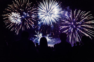 Crowd watching fireworks and celebrating new year eve