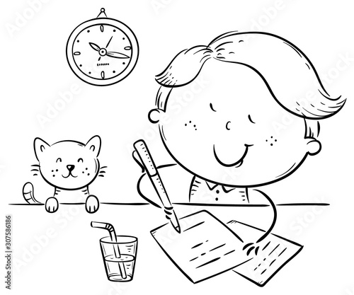Boy writing a letter or making homework at the desk