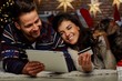 © nyul - Christmas couple shopping on tablet at home