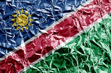 Poster - Namibia flag depicted in paint colors on shiny crumpled aluminium foil closeup. Textured banner on rough background