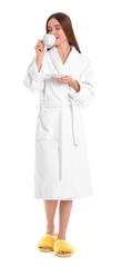 Sticker - Young woman in bathrobe with cup of drink on white background