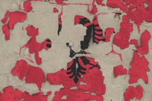 Albania Flag Depicted In Paint Colors On Old Obsolete Messy Concrete Wall Closeup. Textured Banner On Rough Background