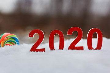 Aufkleber - Red 2020 numbers and Lollipop stand in the snow blurred background.