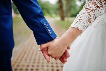 Wall Mural - Wedding day. Hands in hands of newlywed couple.