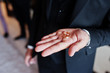 © AS Photo Family - Morning of the groom preparation. Young and handsome groom hold wedding rings on hand.