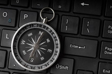 Black And White Compass On Keyboard Background For Direction, Assistance, Guidance And Travel