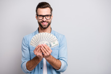 Sticker - Photo of attractive handsome guy holding fan of american money dollars successful freelancer rich person wear specs casual denim outfit isolated grey color background