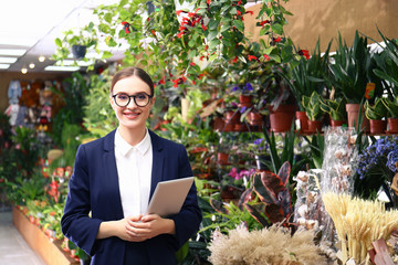 Wall Mural - Female business owner with tablet in flower shop