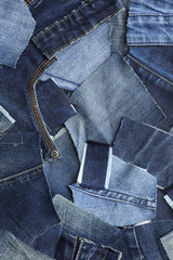 Many patches of old jeans as background, top view