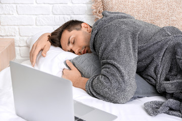 Sticker - Handsome man in bathrobe sleeping on bed