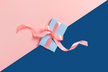 Holiday Card. A Blue Box With A Pink Bow On Two-toned Background.