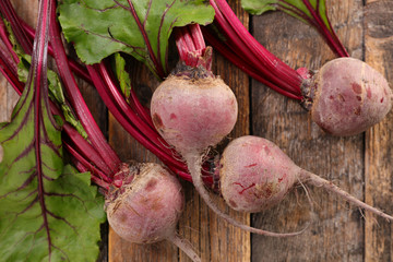 Wall Mural - raw beetroot and leaf on wood background