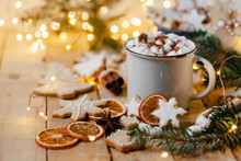 Winter Hot Drink: White Mug With Hot Chocolate With Marshmallow And Cinnamon. Cozy Home Atmosphere, Festive Holiday Mood. Rustic Style, Wooden Background. Homemade Gingerbread Cookies