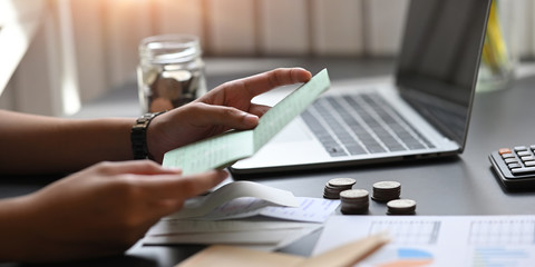 Closeup woman looking her saving account book.