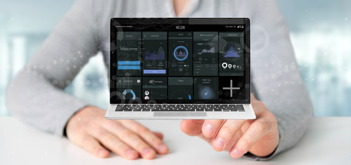 Poster - Businessman holding Laptop with business user interface data on the screen isolated on a background