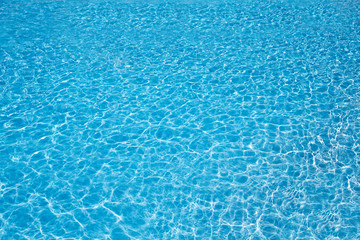 blue pool water with sun reflections