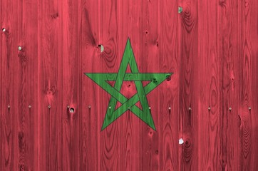 Morocco flag depicted in bright paint colors on old wooden wall. Textured banner on rough background