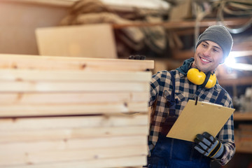 Wall Mural - Young male worker in timber warehouse 